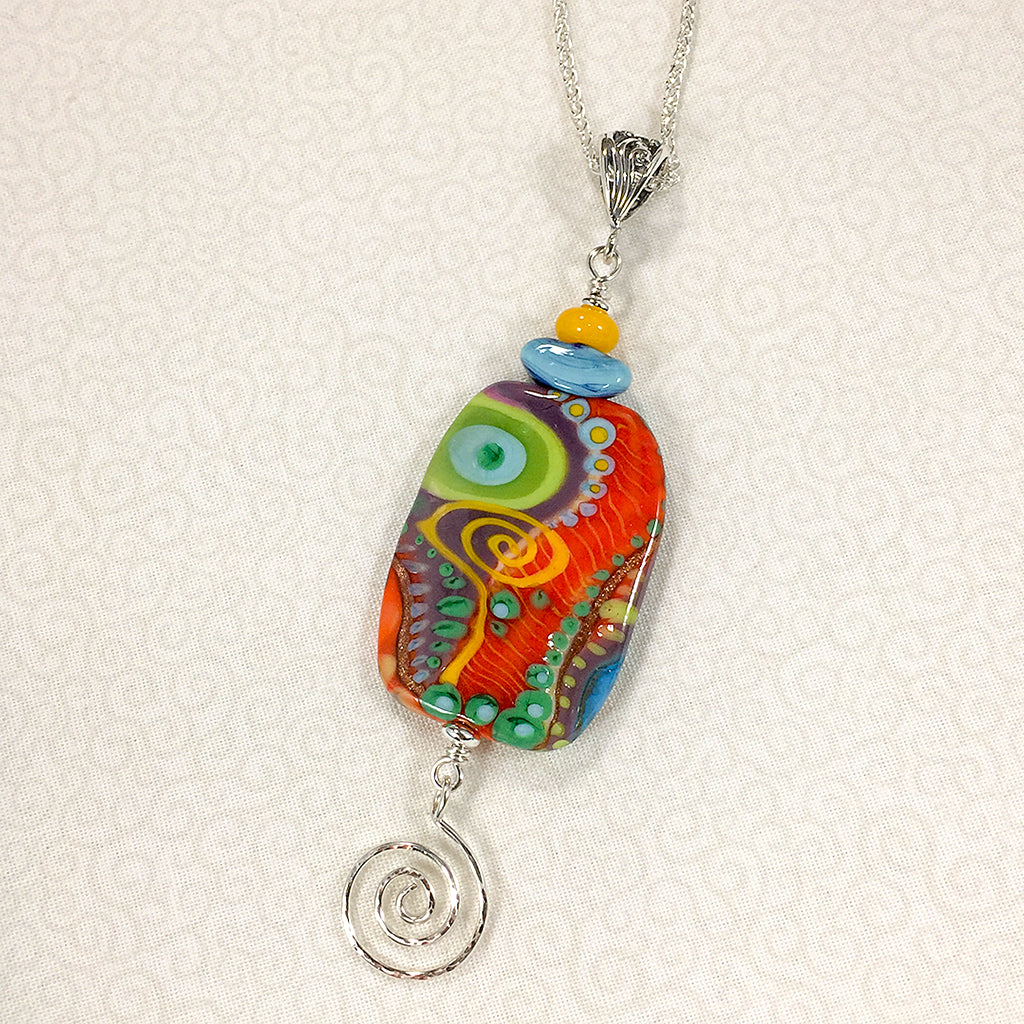 Sterling silver necklace with reversible art glass bead in bright colors and abstract patterns