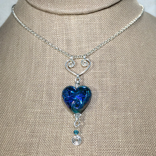 Sterling necklace with iridescent blue art glass heart bead on a handmade heart-shaped pendant