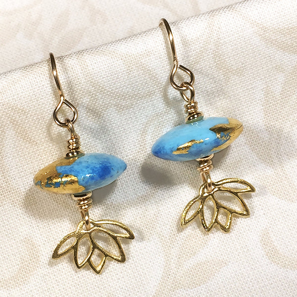 Gold-filled earrings with two-tone blue art glass beads and gold-plated sterling lotus charms