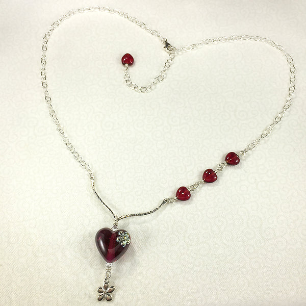 Sterling necklace with wine-red art glass heart bead and silver flowers